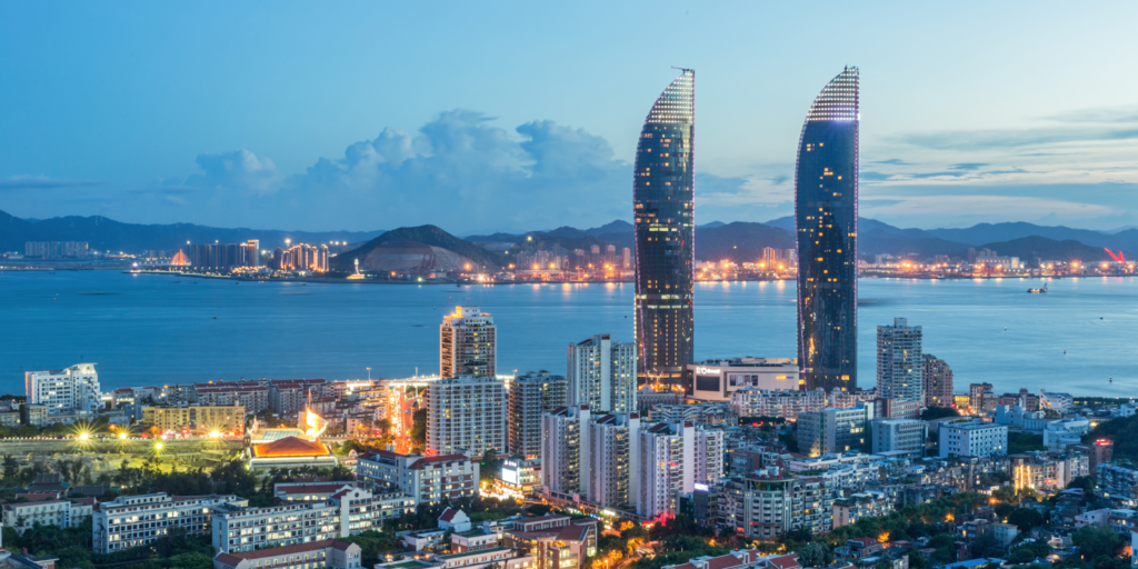 Modern Chinese coastal city skyline representing manufacturing and trade hubs for German businesses sourcing products from China